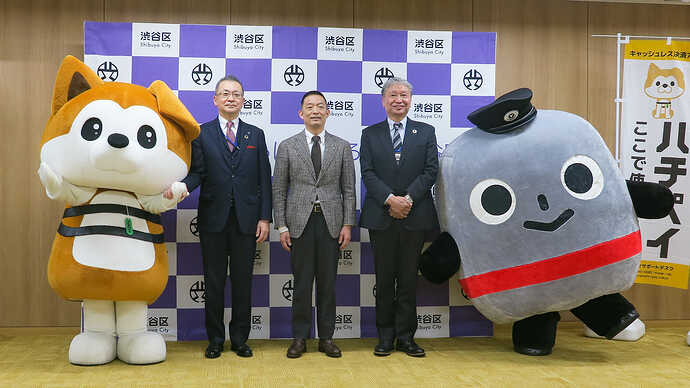 セレモニーで挨拶した（左から）東急バス古川卓社長、長谷部健渋谷区長、EVM-J佐藤裕之社長。渋谷区観光協会キャラ「ラブハチ」＆東急バスキャラ「ノッテちゃん」と記念撮影。