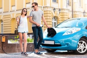 Couple ready to go on electric vehicle